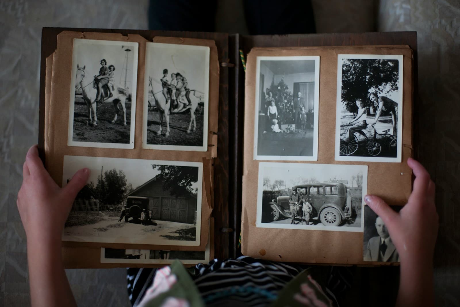 Hands holding an open family photo album